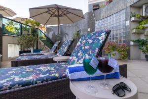 a table with two glasses of wine on a patio at Hotel Golden Park Recife Boa Viagem By Nacional Inn in Recife