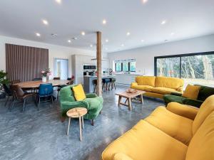 a living room with yellow and green furniture and a table at 4 Bed in Acton oc-k40259 in Waldingfield