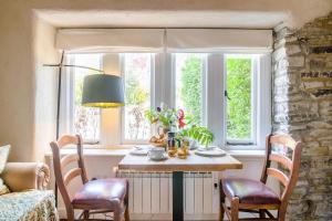 a dining room with a table and chairs and a window at 1 Bed in Alhampton oc-t42458 in Bathampton +13 photos