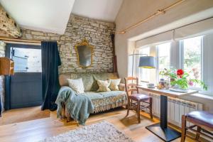 a living room with a couch and a stone wall at 1 Bed in Alhampton oc-t42458 in Bathampton