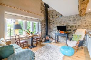 a living room with a stone wall at 1 Bed in Alhampton oc-t42458 in Bathampton