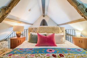 a bedroom with a large bed with colorful pillows at 1 Bed in Alhampton oc-t42458 in Bathampton