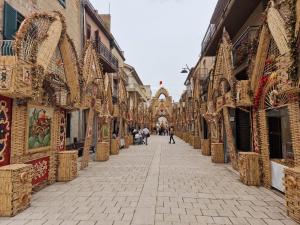 an empty street in a city with many shops at Corte Atenea Guest House Experience & Spa in Agrigento