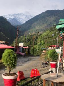 a view of a street with a mountain in the background at Hotel Him darshan in Madheso +25 photos