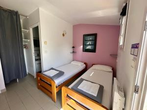 a small room with two beds in it at Le Relais Côtier in Sauzon