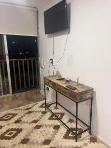 a table in a room with a television on a wall at Playa de Dichato in Dichato