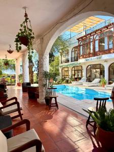 a large building with a swimming pool in a courtyard at Hostal Andino - Adults Only in Cafayate