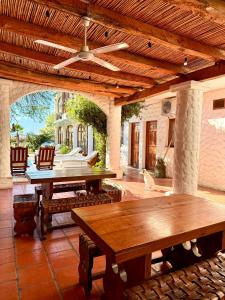 an outdoor patio with wooden tables and chairs at Hostal Andino - Adults Only in Cafayate