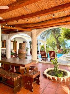 a patio with a table and chairs and a vase at Hostal Andino - Adults Only in Cafayate