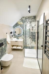 a bathroom with a shower and a toilet and a sink at White House Residence Zator-blisko Energylandii in Zator +102 photos