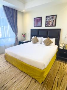 a bedroom with a large bed in a room at Plazza In Hotel in Doha +6 photos