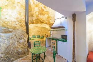 a kitchen with a counter and a table in a room at Casa de la Robledo in Peñaflor