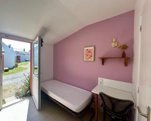 a small room with a bed and a table at Le Relais Côtier in Sauzon +6 photos