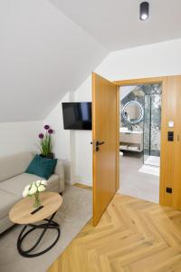 a living room with a couch and a table at White House Residence Zator-blisko Energylandii in Zator