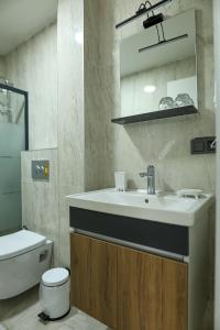 a bathroom with a sink and a toilet at Deluna Yaşamkent in Çankaya +37 photos