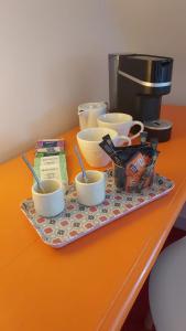 a tray with bowls and utensils on a table at La parenthèse du port in Perros-Guirec +27 photos