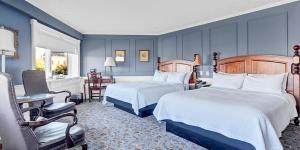 a hotel room with two beds and a desk at St James Hotel in Red Wing +47 photos