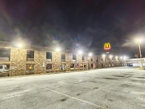 a mcdonalds sign on the side of a building at night at Plaza Hotel By OYO Calumet Park Alsip I 57 in Calumet Park +48 photos