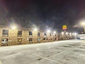 a mcdonalds sign on a brick building at night at Plaza Hotel By OYO Calumet Park Alsip I 57 in Calumet Park