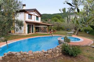 a swimming pool in front of a house at Casa Elisa in Torri del Benaco