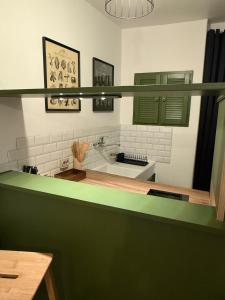 a bathroom with a sink and a green counter at Independent studio on a property in Cognac