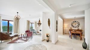 a living room with a clock on the wall at Kotor Bay Villas by Huma in Dobrota