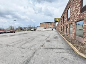 an empty parking lot next to a brick building at Plaza Hotel By OYO Calumet Park Alsip I 57 in Calumet Park