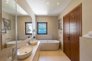 a large bathroom with two sinks and a tub at Kotor Bay Villas by Huma in Dobrota +18 photos