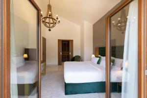 a bedroom with two beds and a mirror at Kotor Bay Villas by Huma in Dobrota