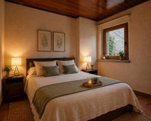 a bedroom with a bed with two lamps and a window at Luxury Rocamar – Primera Línea y Terraza in Tossa de Mar
