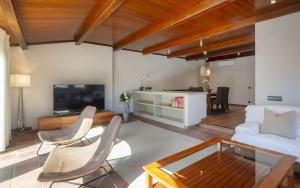a living room with a couch and a table at Luxury Rocamar – Primera Línea y Terraza in Tossa de Mar