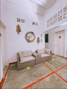 a living room with two couches and a mirror at Casa Vacacional Playa del Sur in Chichiriviche