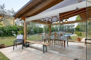 a pavilion with a table and chairs on a patio at Casa Elisa in Torri del Benaco