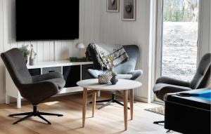 a living room with two chairs and a table at Beautiful Home In Ringkøbing With Sauna in Ringkøbing
