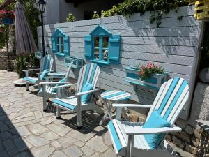 a group of chairs sitting in front of a house at Aegean Villas in Potos