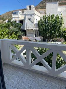 a white fence in front of a white building at studios costareli in Vrachonisída Diapóri +4 photos