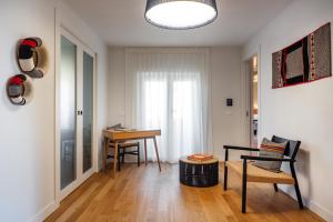 a living room with a table and a chair at Valesmeralda Boutique Rooms, Porto Cervo Marina Adults only in Porto Cervo