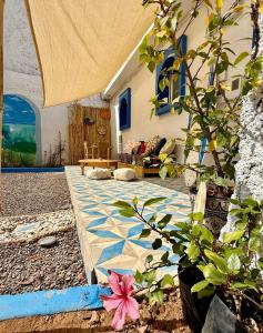 a living room with a stone floor with a table at SeArt Home by the Ocean in Aourir