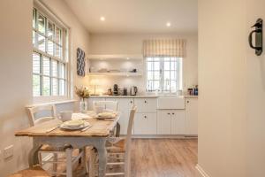 a kitchen and dining room with a table and chairs at 2 Bed in Stoke oc-c41361 in Hurstbourne Tarrant