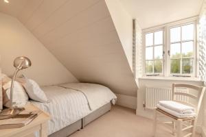 a bedroom with a bed and a desk and window at 2 Bed in Stoke oc-c41361 in Hurstbourne Tarrant