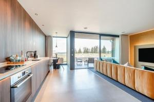 a kitchen with a long counter and a living room at 1 Bed in Oban oc-t41733 in Acharra
