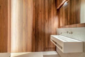 a bathroom with a white sink and wooden walls at 1 Bed in Oban oc-t41733 in Acharra +16 photos