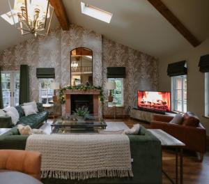 a living room with a couch and a fireplace at Noble Fir Lodge - The Hollies Retreats in Oakmere