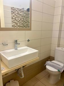 a bathroom with a sink and a toilet at Sylvia Studios in Agia Marina Aegina +18 photos