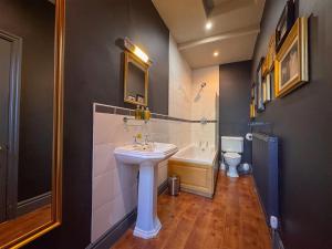 a bathroom with a sink and a tub and a toilet at The Fat Badger in York +27 photos