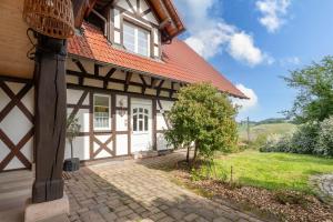 a house with an orange roof and a brick driveway at Ferienwohnung Erdgeschoss in Durbach
