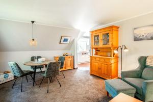 a living room with a table and chairs and a couch at Haus-Margarete-Westwind in Kampen