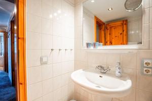 a bathroom with a sink and a mirror at Haus-Margarete-Westwind in Kampen +28 photos