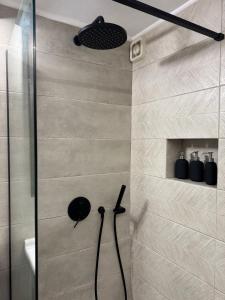 a shower with a black shower head in a bathroom at Saguaro’s home Kavala in Kavála +40 photos