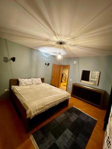 a bedroom with a bed and a ceiling at Cozy Home in Peje +22 photos